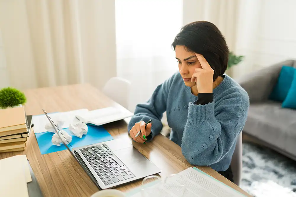 Overcoming Writer's Block and Burnout Frustrated female writer experiencing creative block, typing on laptop while sitting at home